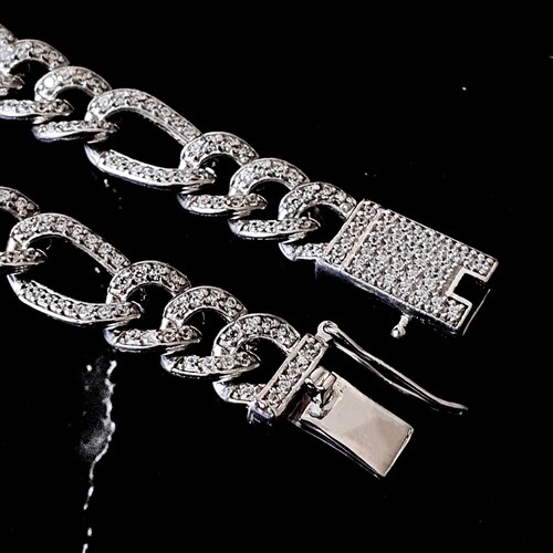 Esclava figaro de zirconias de plata .925 con baño de rodio y broche de caja.