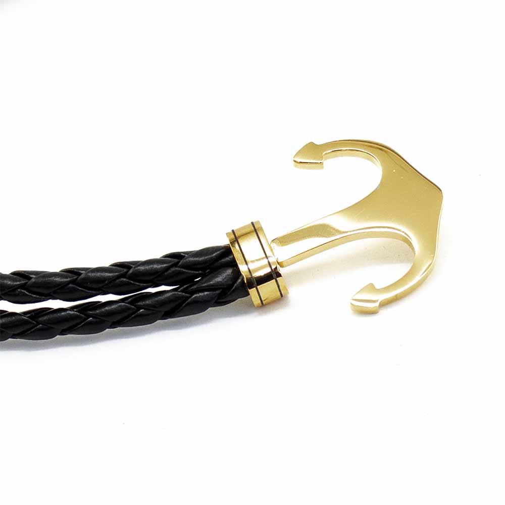 Pulsera Acero NK de piel trenzada con ancla dorada.