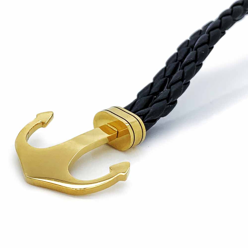 Pulsera Acero NK de piel trenzada con ancla dorada.